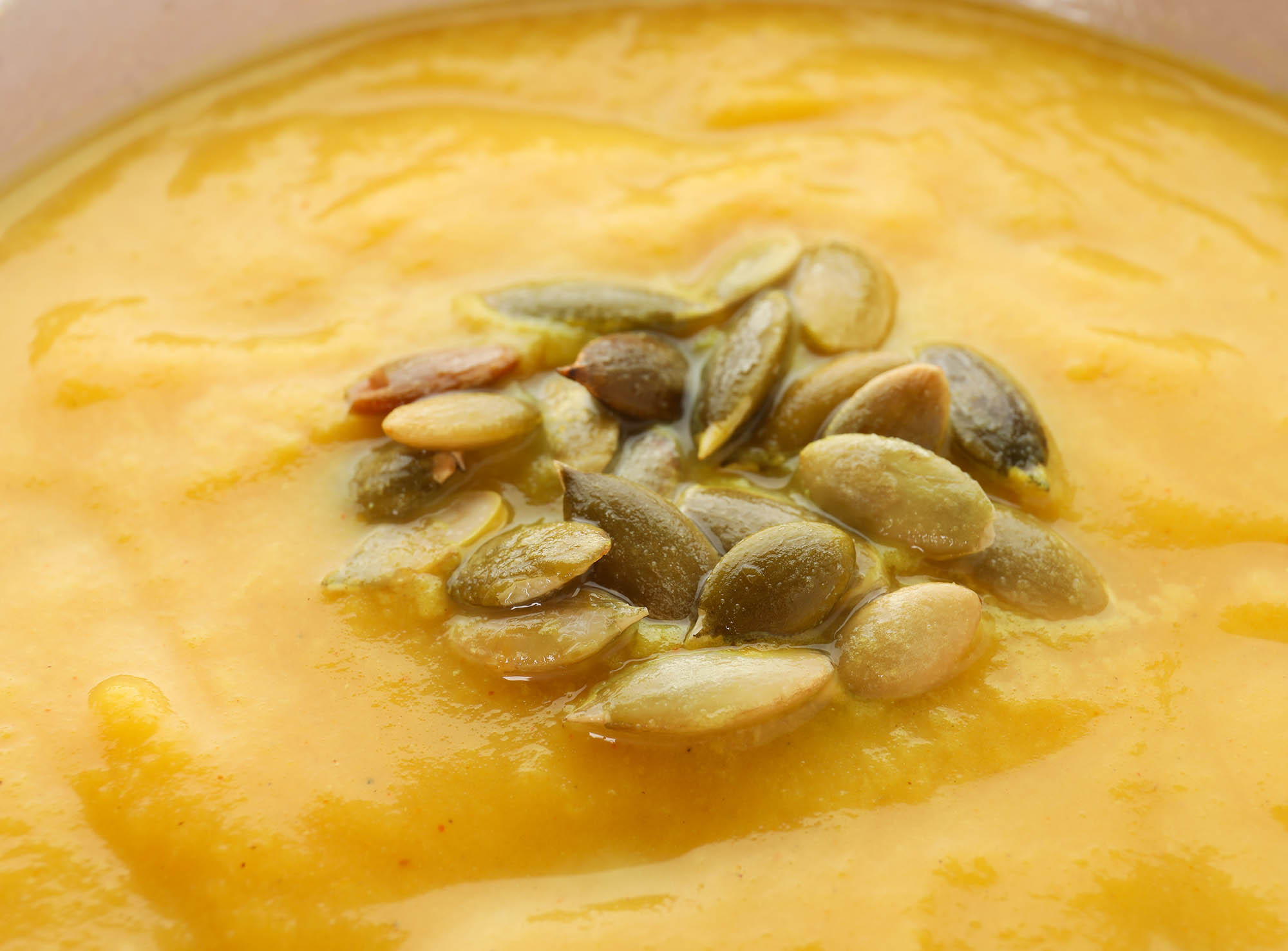 Pumpkin cream soup with seeds, close up